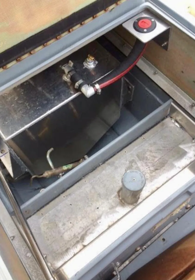 Slide: The Image of Battery compartment of a 2001 Willard 25 boat with wiring and connections. - 13
