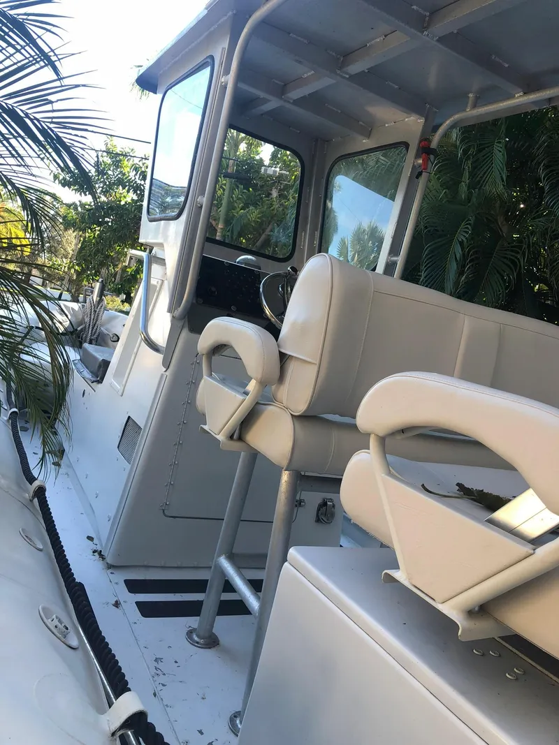 Slide: The Image of 2001 Willard 25 boat interior with seating and steering console. - 19