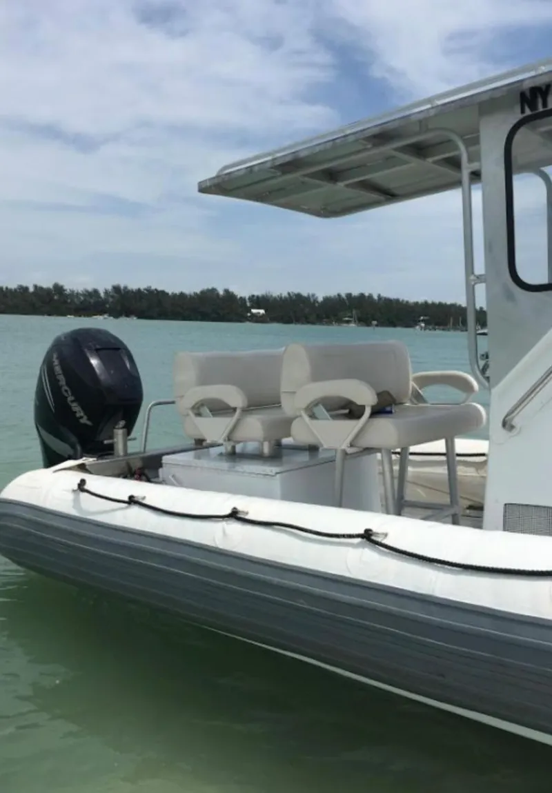 Slide: The Image of 2001 Willard 25 boat on calm water with outboard motor. - 5