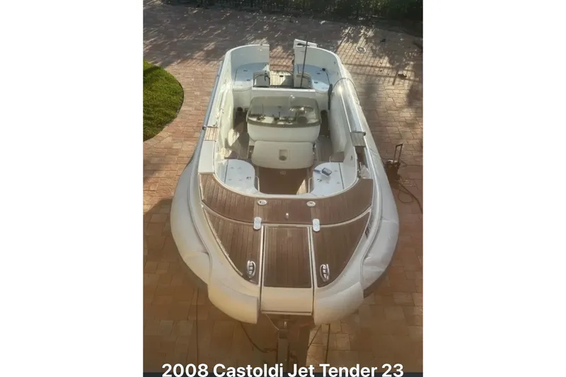 Slide: The Image of 2008 Castoldi Jet Tender 23 boat with wooden deck, parked on brick pavement. - 3