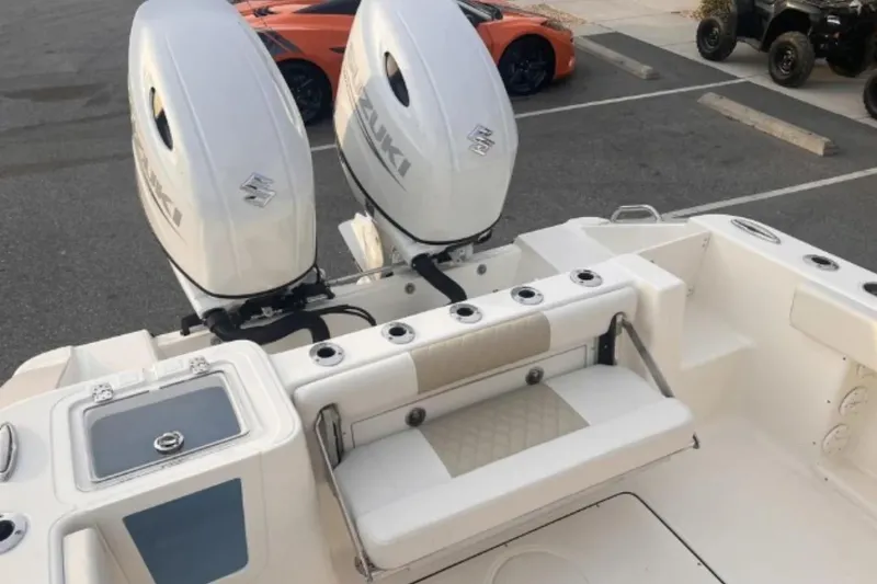 Slide: The Image of 2026 Bulls Bay 255CC boat with dual Suzuki outboard engines in a parking lot. - 4