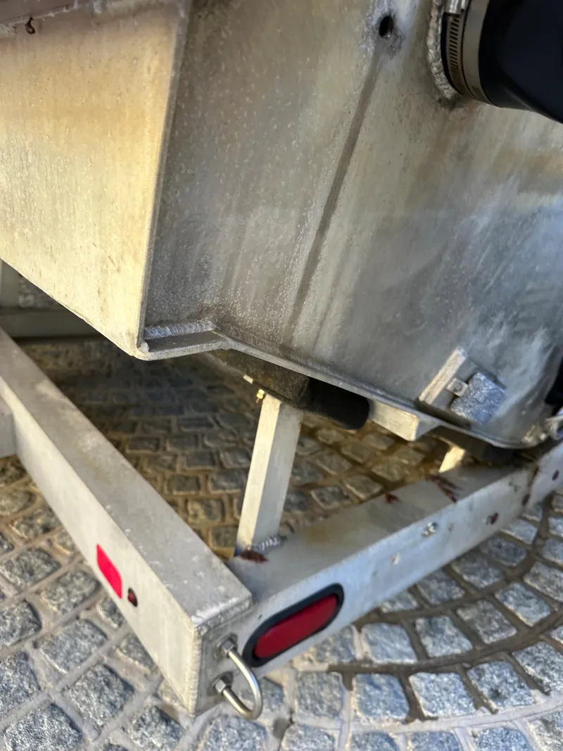Slide: The Image of Close-up of a 2008 Zodiac 24 boat trailer with visible wear and tear. - 16