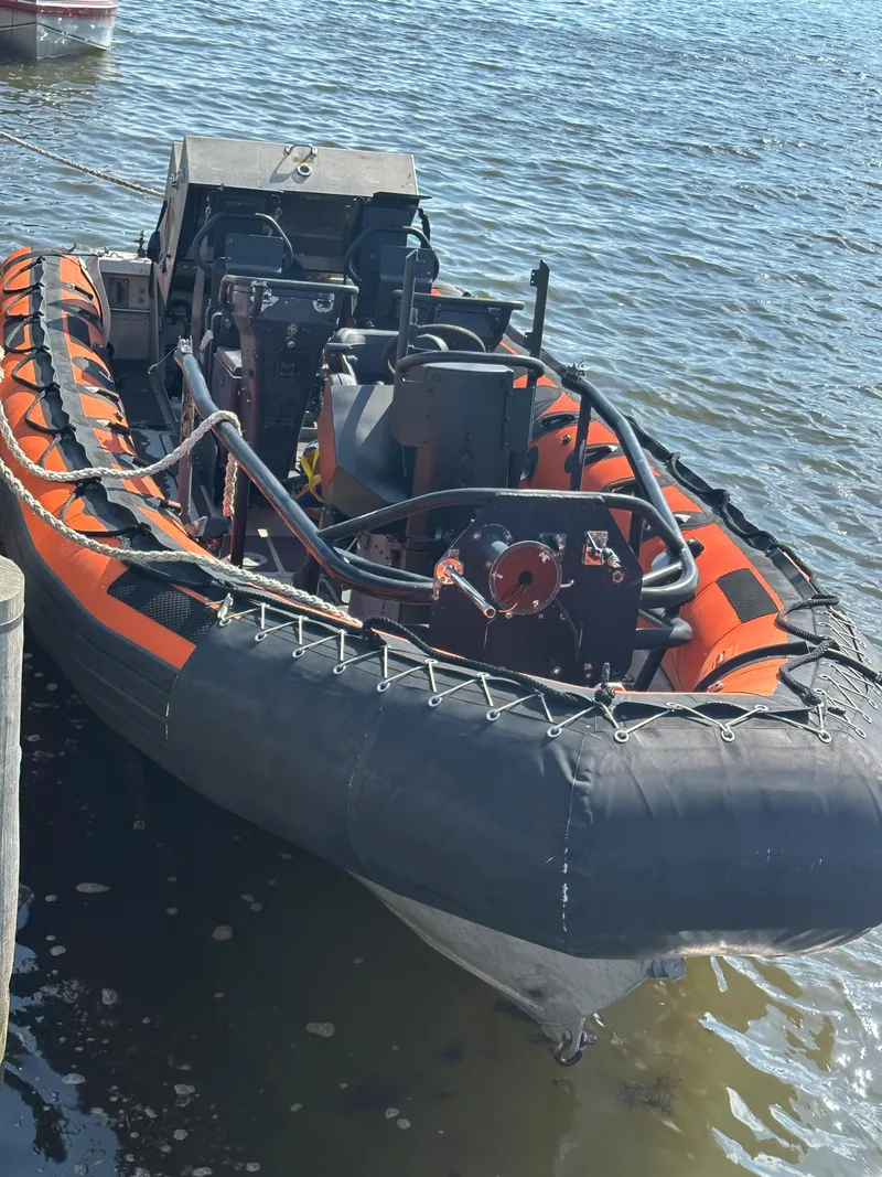 Slide: The Image of 2008 Zodiac 24 inflatable boat docked on water. - 2