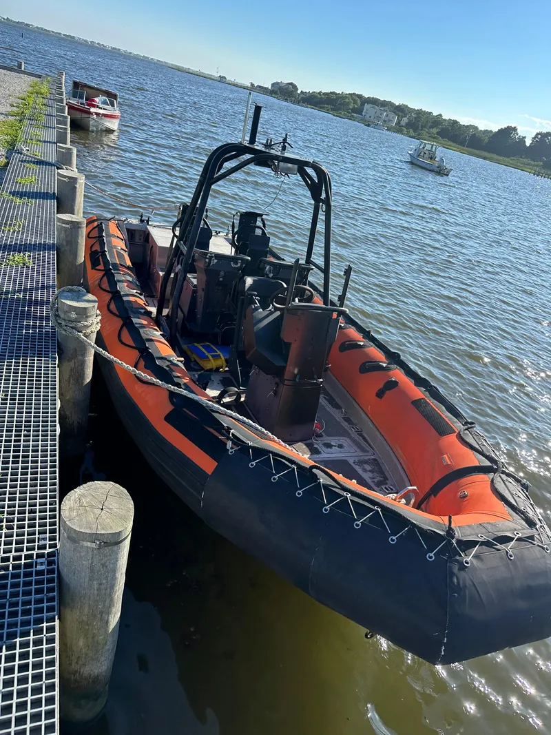 Slide: The Image of 2008 Zodiac 24 boat docked by the lake. - 3
