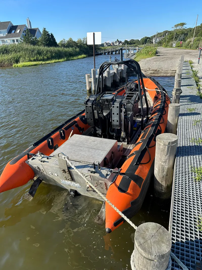 Slide: The Image of Orange Zodiac 24 boat docked by a riverside, 2008 model. - 4