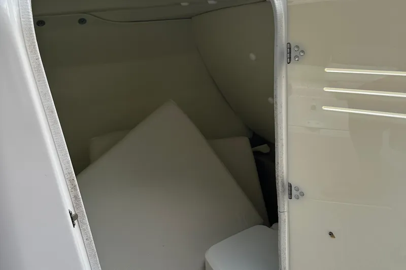 Slide: The Image of Interior storage compartment of 2012 Yamaha Boats 242 Limited S, featuring cushions and a closed door. - 14