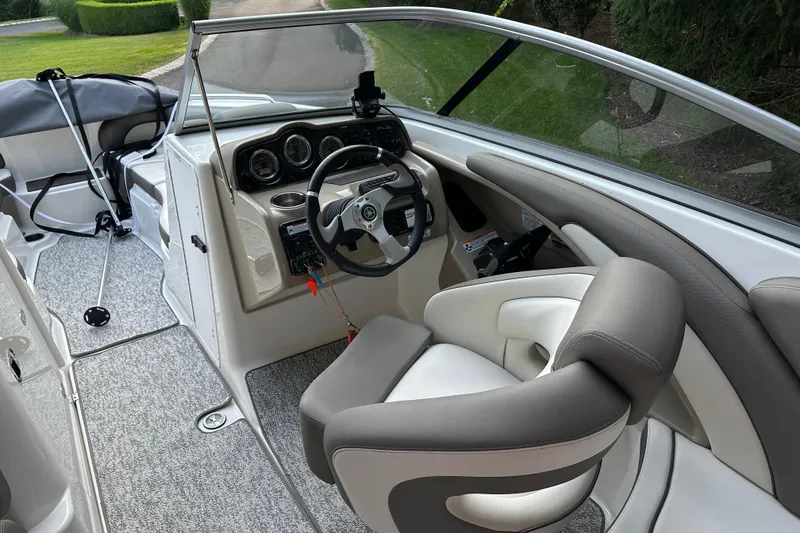 Slide: The Image of 2012 Yamaha Boats 242 Limited S interior with steering wheel and seating. - 8