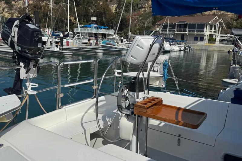 Slide: The Image of Cockpit of a 1994 Catalina 320 sailboat docked at a marina with outboard motor. - 16