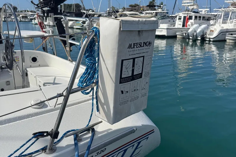 Slide: The Image of Catalina 320 sailboat with Lifesling rescue system, docked in a marina, 1994 model. - 20