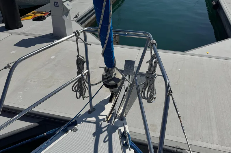 Slide: The Image of Bow of a 1994 Catalina 320 sailboat docked at a marina. - 21