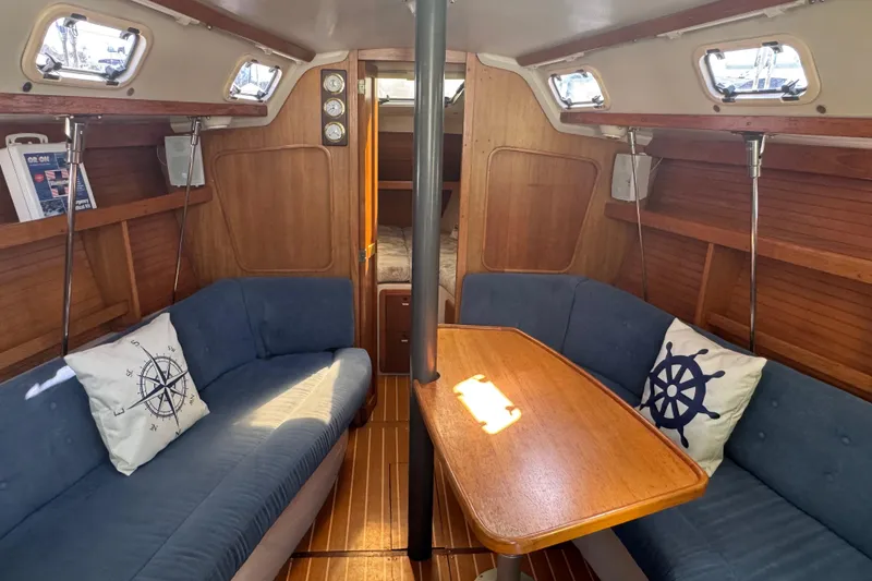 Slide: The Image of Interior of 1994 Catalina 320 sailboat with cozy seating and nautical decor. - 27
