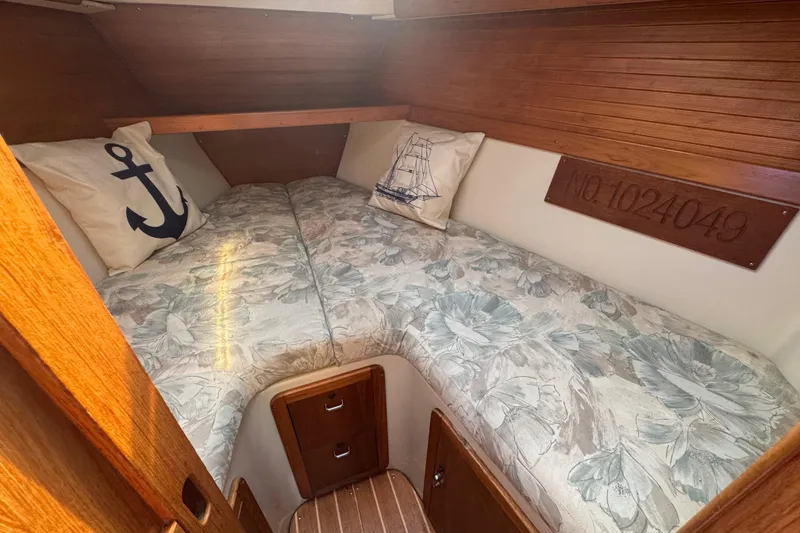 Slide: The Image of Cozy cabin interior of 1994 Catalina 320 sailboat with floral bedding and nautical decor. - 30