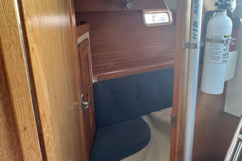 Slide: The Image of Interior of 1994 Catalina 320 sailboat with wooden paneling and seating area. - 35