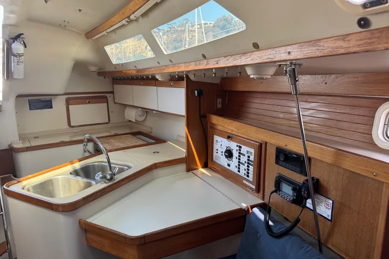 Slide: The Image of Interior of a 1994 Catalina 320 sailboat with kitchen and control panel. - 39