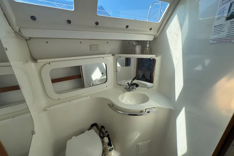 Slide: The Image of Interior of 1994 Catalina 320 sailboat bathroom with sink and mirror. - 42
