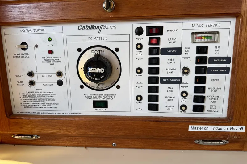 Slide: The Image of Control panel of a 1994 Catalina 320 yacht with various switches and indicators. - 46