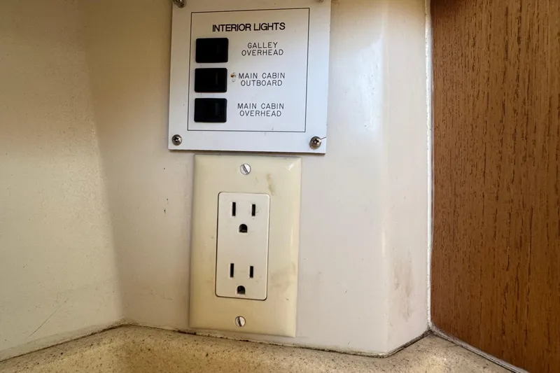 Slide: The Image of Interior light switches and power outlet on a 1994 Catalina 320 yacht. - 47