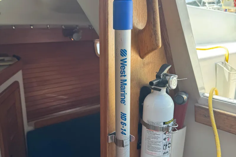 Slide: The Image of Interior of a 1994 Catalina 320 sailboat with fire extinguisher and West Marine equipment. - 48