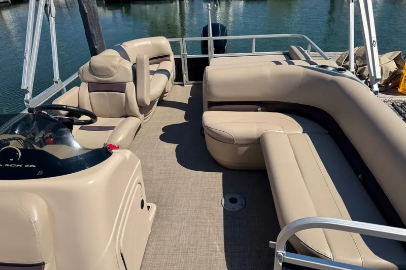 Slide: The Image of 2017 Sun Tracker Party Barge 22 DLX pontoon boat with beige seating and steering console. - 10