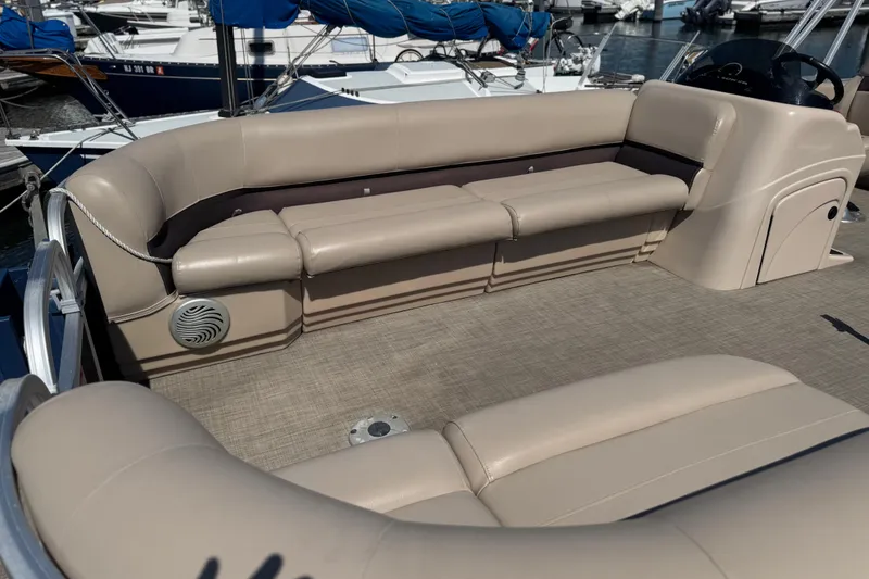 Slide: The Image of 2017 Sun Tracker Party Barge 22 DLX with beige seating in a marina setting. - 11