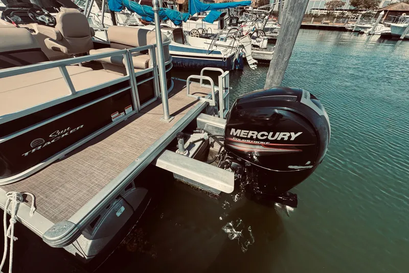 Slide: The Image of 2017 Sun Tracker Party Barge 22 DLX with Mercury outboard motor docked at marina. - 5