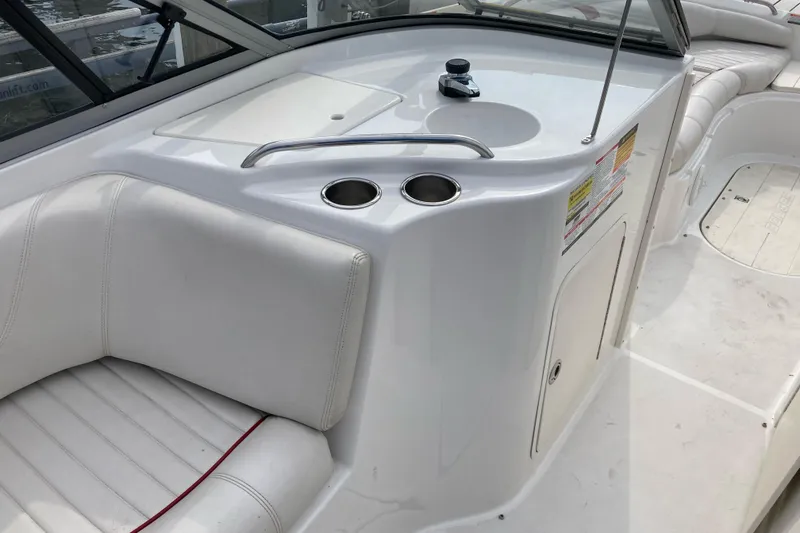 Slide: The Image of 2005 Ebbtide 2400 Fun Cruiser DC interior with white seating and built-in sink. - 12