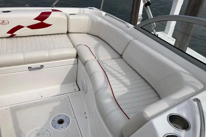 Slide: The Image of 2005 Ebbtide 2400 Fun Cruiser DC boat interior with white seating and red accents. - 13