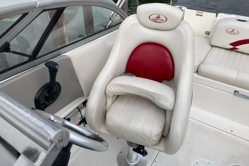 Slide: The Image of 2005 Ebbtide 2400 Fun Cruiser DC boat interior with white and red seating. - 9