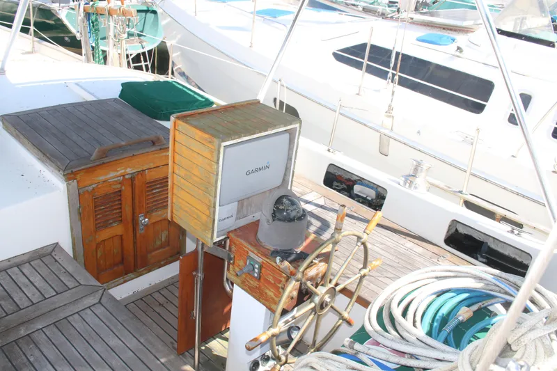 Slide: The Image of Cockpit of 1981 Hardin 45 Voyager sailboat with Garmin navigation system and wooden wheel. - 12
