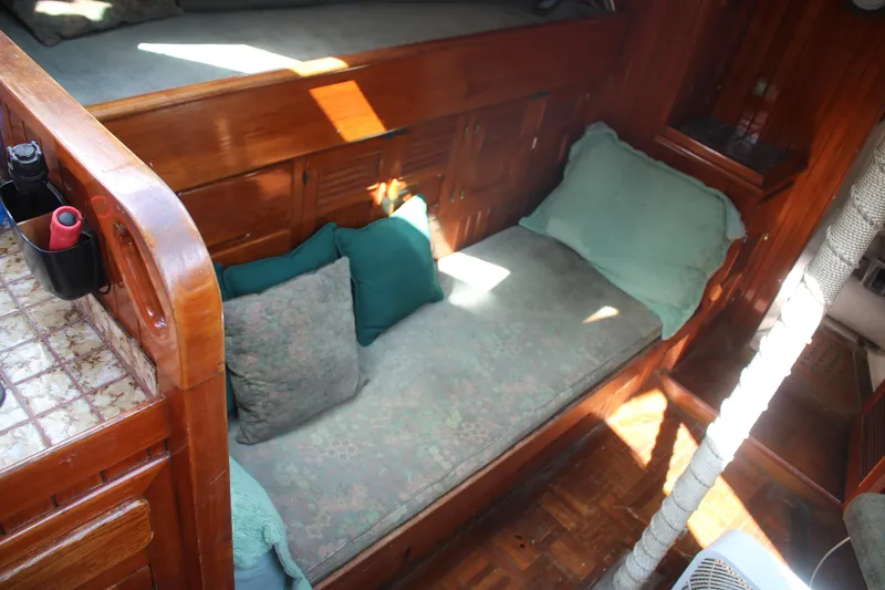 Slide: The Image of Cozy interior of 1981 Hardin 45 Voyager sailboat with wooden finish and cushions. - 18