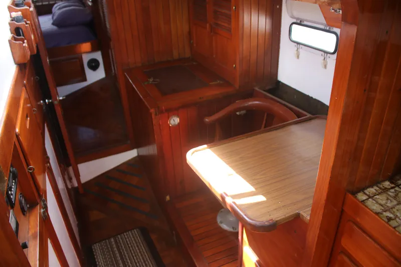 Slide: The Image of Interior of 1981 Hardin 45 Voyager sailboat with wooden cabinetry and cozy layout. - 24