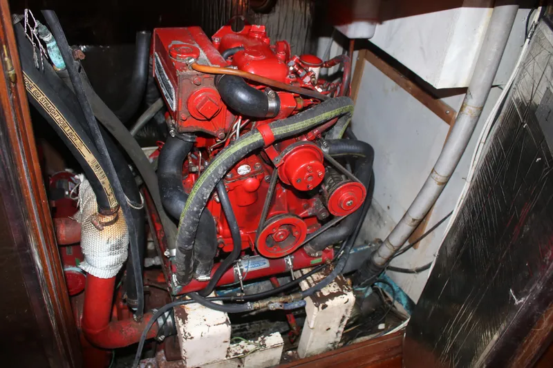 Slide: The Image of Engine compartment of a 1981 Hardin 45 Voyager sailboat, featuring a red marine engine. - 28