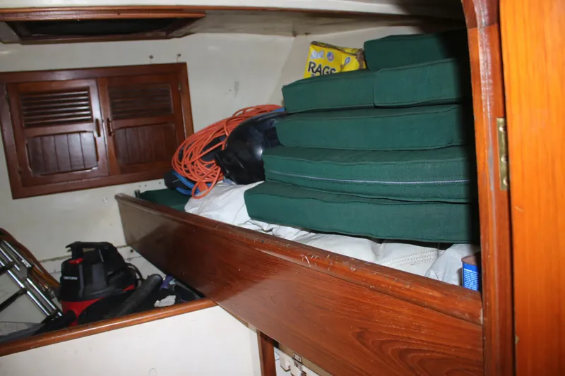 Slide: The Image of Storage area inside 1981 Hardin 45 Voyager with cushions, rope, and cleaning supplies. - 35