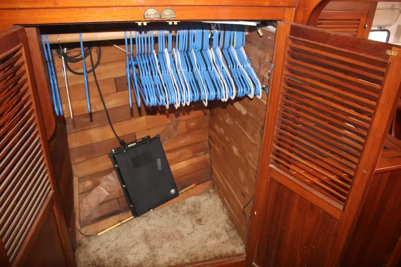 Slide: The Image of Wooden closet with blue hangers inside a 1981 Hardin 45 Voyager boat. - 41