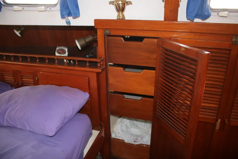 Slide: The Image of Wooden interior of 1981 Hardin 45 Voyager with open drawers and purple bedding. - 42