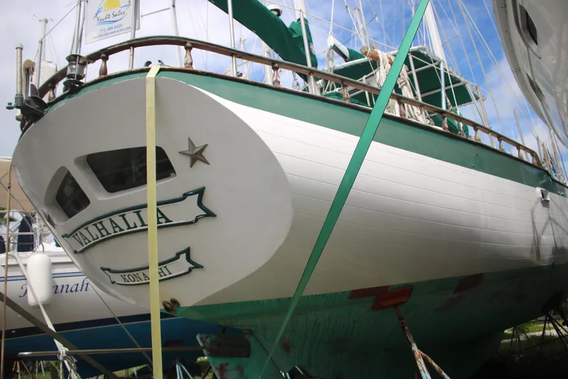 Slide: The Image of 1981 Hardin 45 Voyager sailboat, named Valhalla, docked and secured with straps. - 7