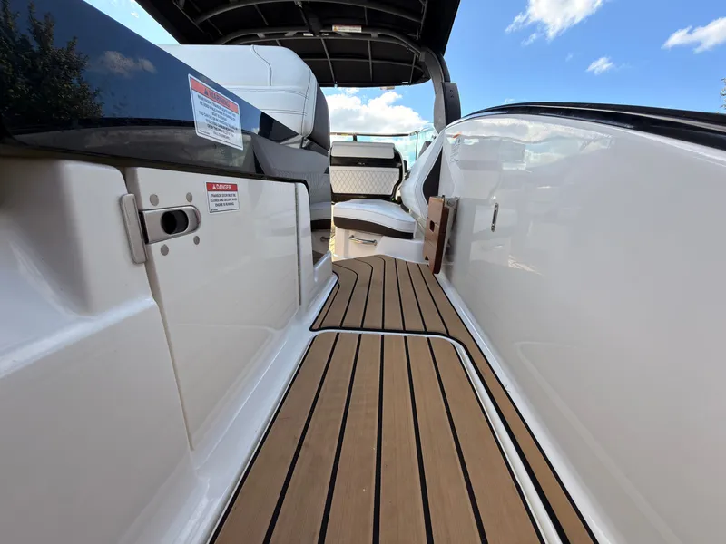 Slide: The Image of The image shows the deck of a 2026 Sea Ray SLX 280 Outboard with sleek wooden flooring. - 30
