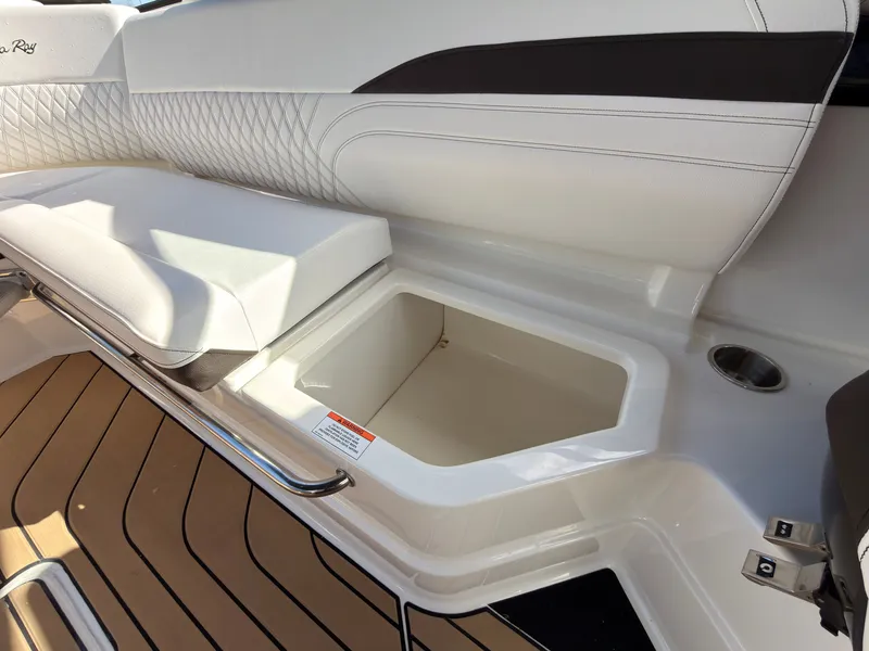 Slide: The Image of The image shows the seating area of a Sea Ray SLX 280 Outboard with an open storage compartment. - 48