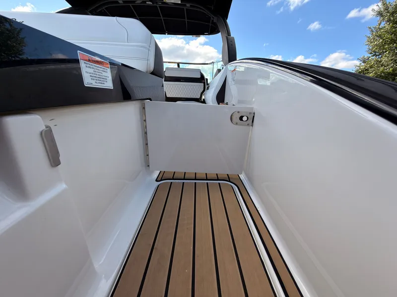 Slide: The Image of The image shows the deck of a Sea Ray SLX 280 Outboard with wood-like flooring and white seats. - 31