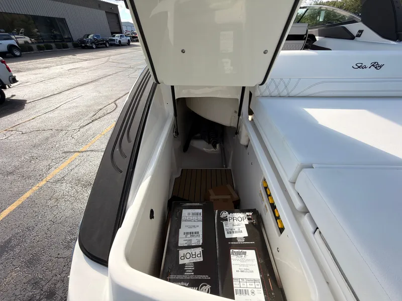 Slide: The Image of A storage compartment on a Sea Ray SLX 280 Outboard boat with various items inside. - 26