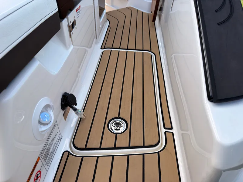 Slide: The Image of The image shows the teak deck of a 2026 Sea Ray SLX 280 Outboard with sleek lines. - 17