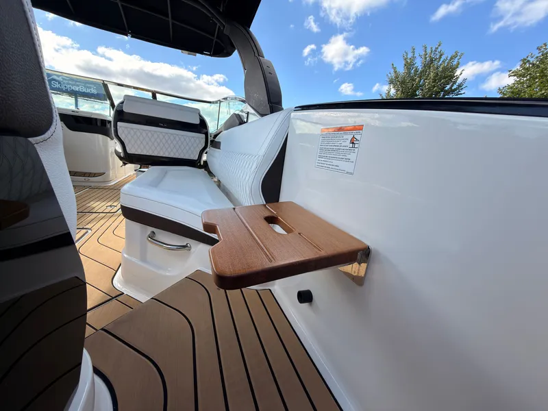 Slide: The Image of The image shows the interior of a Sea Ray SLX 280 Outboard with sleek seating and a foldable table. - 35