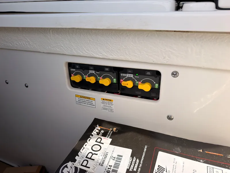 Slide: The Image of Control panel with yellow rotary switches and labels on a Sea Ray SLX 280 Outboard. - 27