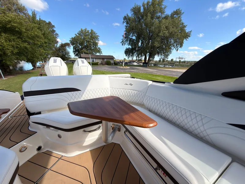 Slide: The Image of The image shows the luxurious cockpit of a Sea Ray SLX 280 Outboard with elegant white upholstery and a wooden table. - 37