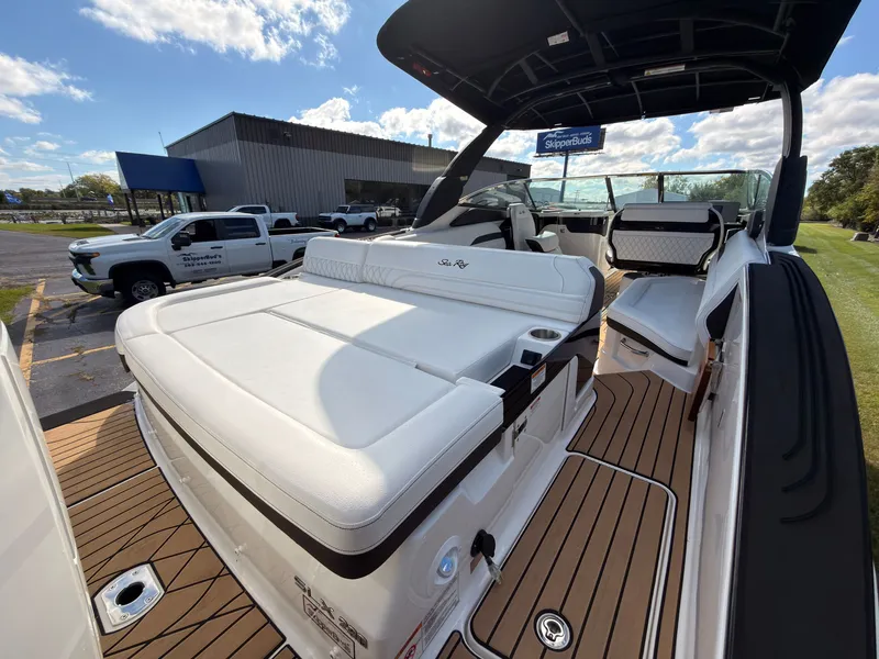 Slide: The Image of The image shows a 2026 Sea Ray SLX 280 Outboard boat with luxurious white upholstery and teak flooring. - 16