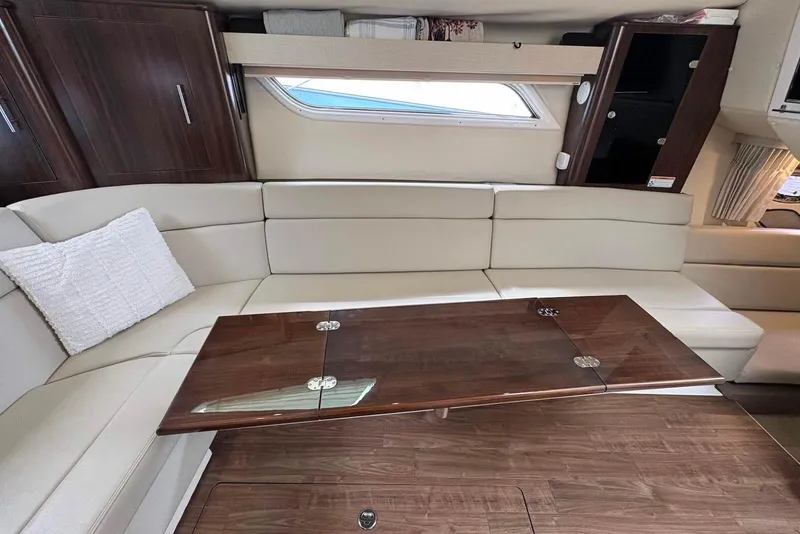 Slide: The Image of Luxurious interior of 2016 Regal 35 Sport Coupe with elegant seating and wooden table. - 10