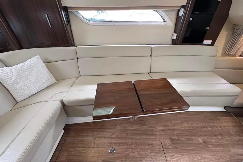 Slide: The Image of Luxurious interior of 2016 Regal 35 Sport Coupe with cream seating and wooden table. - 11