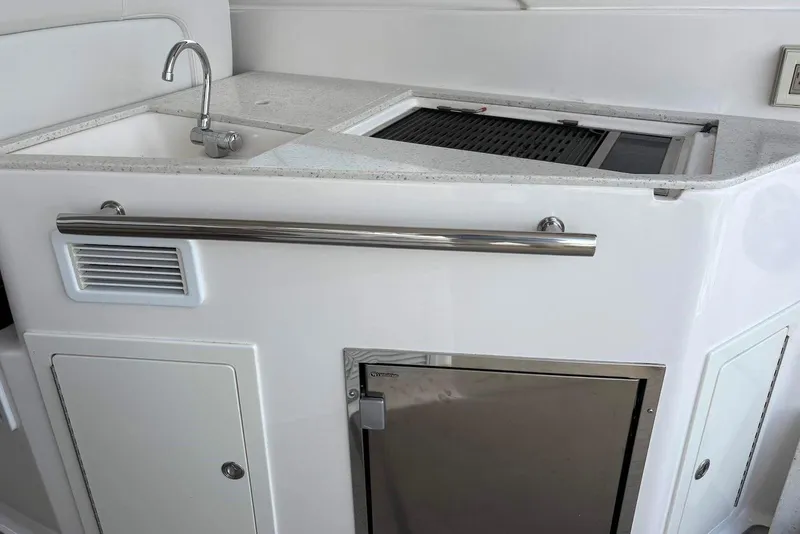 Slide: The Image of 2016 Regal 35 Sport Coupe yacht kitchenette with sink and storage. - 14