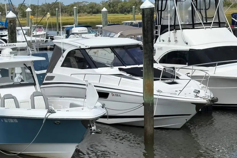 Slide: The Image of 2016 Regal 35 Sport Coupe docked among other boats in a marina. - 2