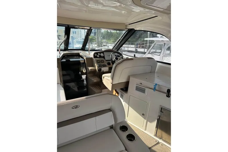 Slide: The Image of Interior of 2016 Regal 35 Sport Coupe yacht with helm and seating area. - 7